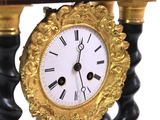 a clock that is sitting on a table with a book