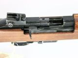 the rifle has a wooden barrel and a metal sighter on it