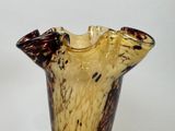 a glass vase that has a brown and black design on it
