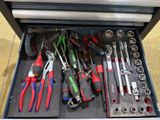 many tools in a tool box on the floor