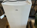 a white refrigerator sitting on a pallet in a warehouse