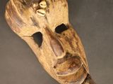 vue de dessus d'un masque en bois accroché à un mur
