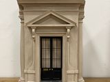 a small model of a building on a wooden table