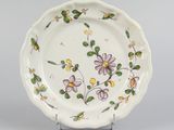 underside view of a plate with flowers and leaves painted on it