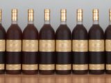 six bottles of wine lined up in a row on a table