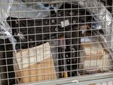 a metal cage filled with boxes and bags of items