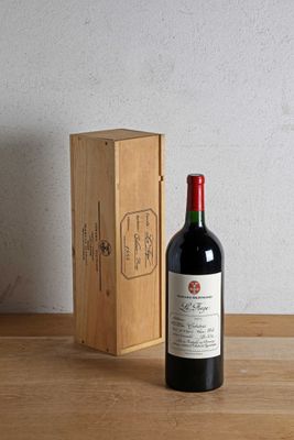 a bottle of wine sitting next to a box on a table