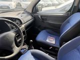 dashboard of a car with blue seats and steering controls