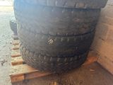 a tire that is sitting on a pallet next to a wall