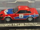 a model of a red car in a clear display case