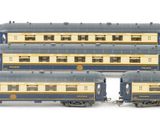 six blue and white train cars sitting next to each other on a white surface