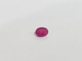 a pink stone on a white surface