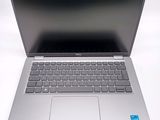 an open laptop computer sitting on top of a white table