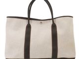 a white and brown tote bag sitting on top of a white surface