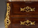 an antique chest of drawers with a marble top and gold accents