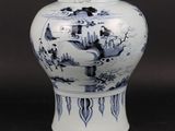 a blue and white vase with a lid sitting on a table