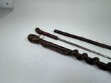 two different types of swords on a white table
