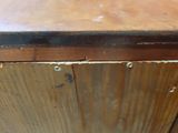 a wooden table with a metal top in a room