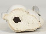 a small white object with a hole in it