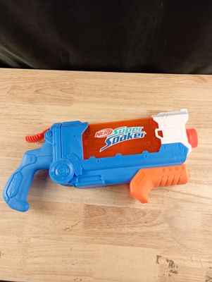 a blue and orange water gun on a wooden table