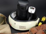 a camera, a camera case, a belt, and a watch on a black background
