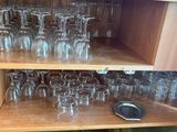 many glasses on the shelves in the kitchen