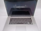 a silver laptop computer sitting on a white surface