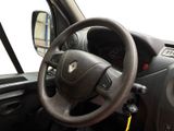 a steering wheel and dashboard of a car on a street