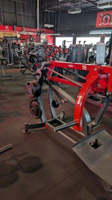 a gym with a row of machines in the background