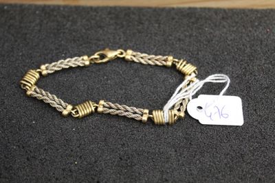 a close up of a bracelet with a tag on it