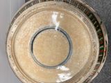 a bowl that is sitting on the floor next to a wall