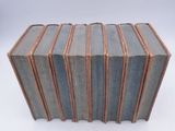 several books stacked on top of each other on a white surface