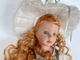 a doll that is wearing a hat with flowers on it