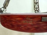a wooden bowl hanging from a chain on a wall