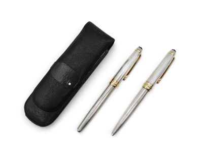 two pens and a case sitting on top of a white surface