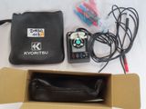 a box with a remote control and other items in it