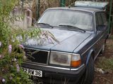 a car that is parked next to a fence