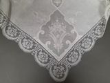 a close up of a white table cloth with a design on it