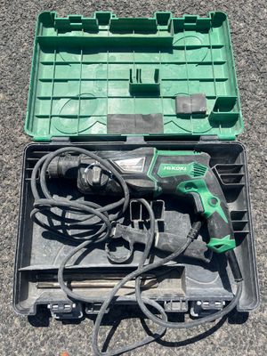 a green box with tools in it sitting on the ground