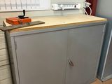 a metal cabinet in the corner of a room next to a wall