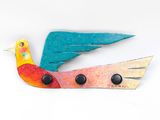 a bird that is sitting on top of a pair of scissors