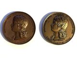 two gold coins with a woman ' s face on them