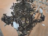 a chandelier that has a bunch of flowers on it