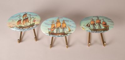 three small wooden stools with a painting of a ship on them