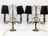 pair of black and gold table lamps with black shades on them