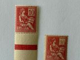 two red and white postages on a white surface