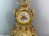 a gold clock that is sitting on the floor