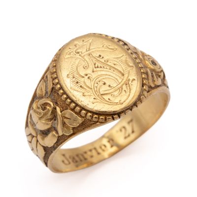 an image of a gold ring with a coin in the center