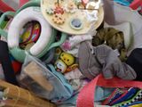 a pile of baby items and toys in a basket