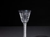 a close up of a wine glass on a table with a black background